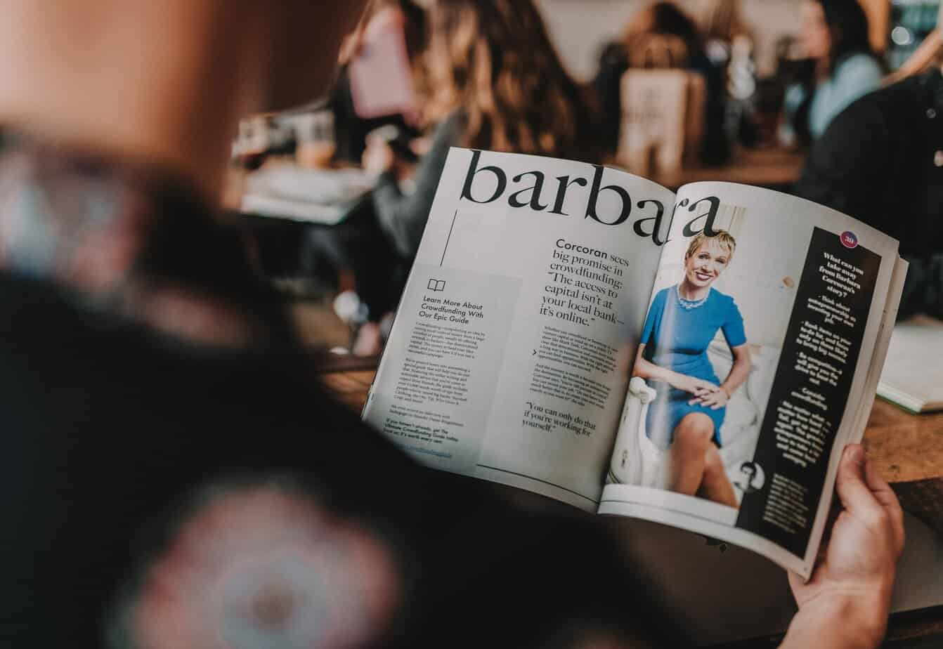 Person reading a magazine with article about Barbara Cocharan 
